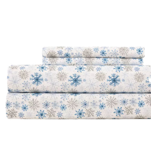 Set of bed sheets with a snowflake pattern in blue and gray on a white background.