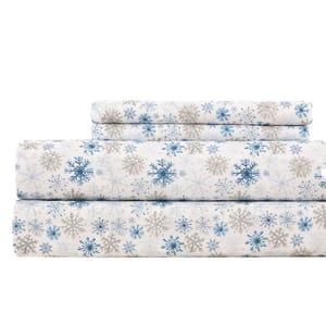 Set of bed sheets with a snowflake pattern in blue and gray on a white background.