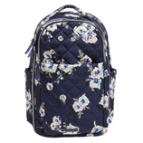 A navy floral quilted backpack featuring multiple compartments, side pockets, and zipper closures.
