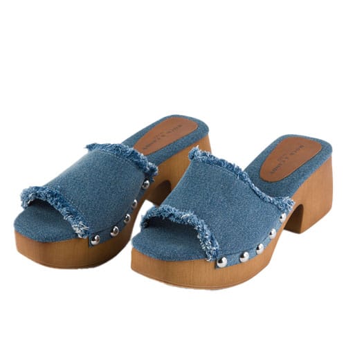 Denim platform slide sandals with a frayed edge design, wooden block heel, and metallic stud accents along the sides.
