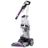 A Hoover SmartWash carpet cleaner with a cleaning wand and a red silicone mat accessory.