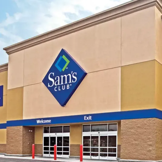 Sam's Club storefront featuring a large sign with its logo above sliding glass entrance and exit doors.