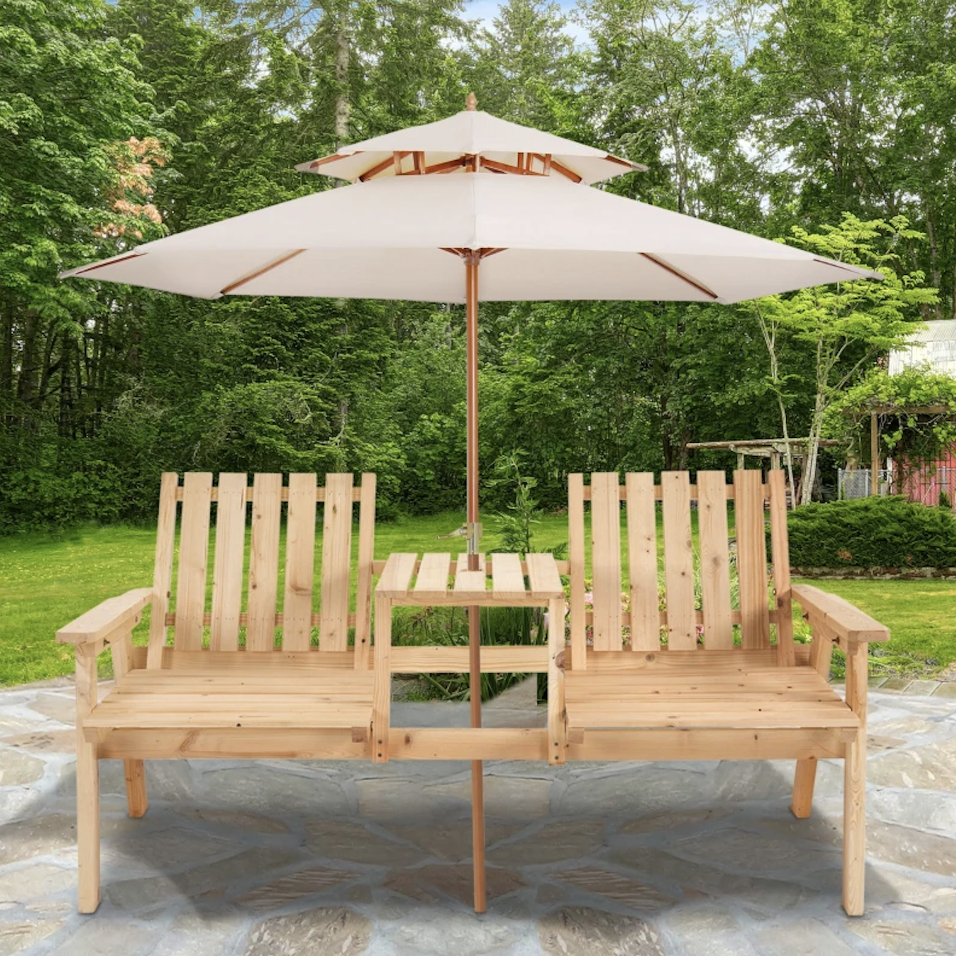 Wooden double chair set with a central table and integrated umbrella, placed on a stone patio with a green garden backdrop.