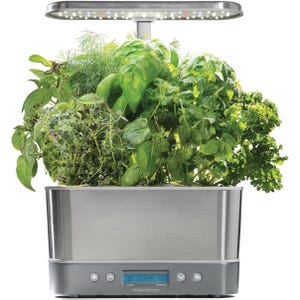 The AeroGarden Harvest Elite Indoor Garden is a compact, stainless steel hydroponic system with an LED grow light, allowing you to grow various herbs indoors. It features a digital control panel for easy maintenance and monitoring.
