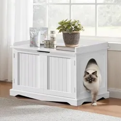White wooden cat litter box enclosure with side entry, topped with a potted plant and cat food items.