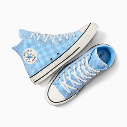 A pair of light blue Converse high-top sneakers with white laces and rubber soles.