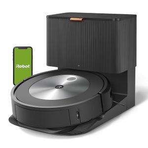 Refurbished iRobot Roomba with automatic emptying base, accompanied by a smartphone displaying the iRobot app. It features a sleek, modern design in black and silver.