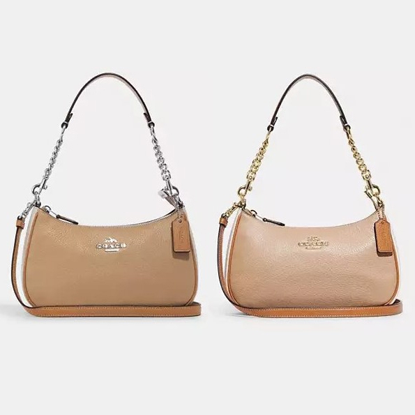 Two tan leather shoulder bags, one with a silver chain strap and the other with a gold chain strap.