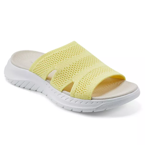 Yellow mesh slip-on sandal with a white contoured sole and open-toe design.
