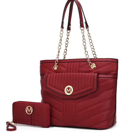 A red quilted handbag with gold chain straps and a matching wallet, both featuring a decorative \“M\“ emblem.