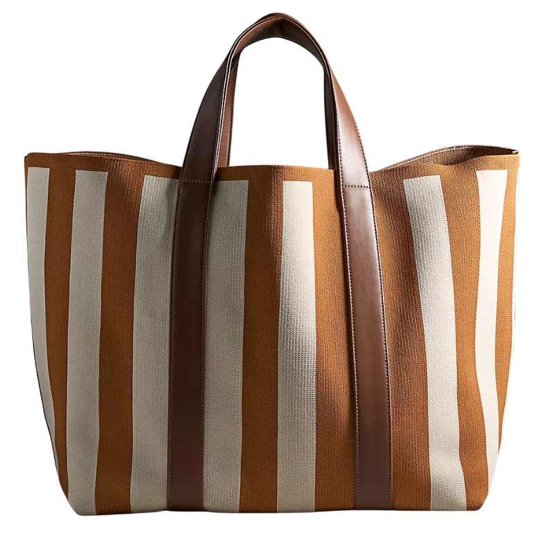 A brown and white striped tote bag with leather handles, featuring a wide open top design for easy access.