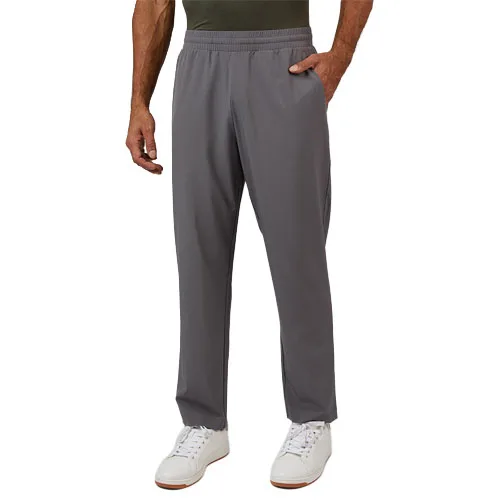 Gray men's athletic pants with an elastic waistband and side pockets, paired with white sneakers.