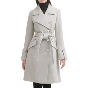 A light gray, double-breasted coat with a belted waist, wide lapels, and front flap pockets. The cuffs have button details, and the coat has a tailored, knee-length fit.