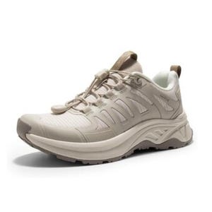 A beige athletic sneaker featuring a textured sole, lace-up closure with a pull-tab, and a breathable mesh upper.