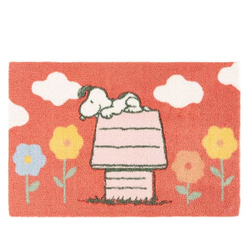 A rectangular mat with a cartoon dog lying on a red doghouse, surrounded by colorful flowers and clouds on a red background.