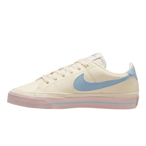 A cream-colored Nike sneaker with a light blue swoosh and pink accents on the sole.