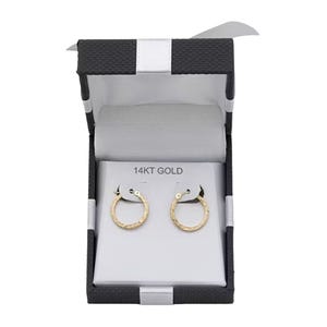 A pair of 14K gold hoop earrings displayed in a black and white box.
