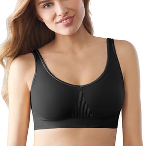 A woman is wearing a black Bali One Smooth U Bralette. The bralette features wide straps and a smooth, seamless design with ribbed detailing at the center.