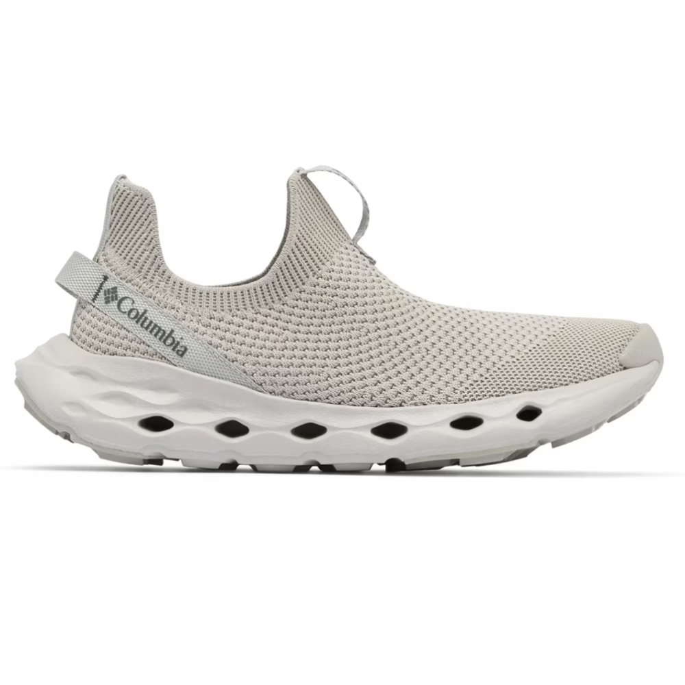 A Columbia slip-on shoe with a light gray knit upper and a cushioned sole featuring ventilation holes.