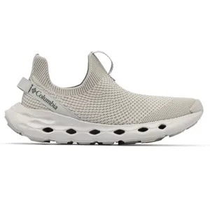 A Columbia slip-on shoe with a light gray knit upper and a cushioned sole featuring ventilation holes.