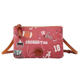 Dooney & Bourke crossbody bag featuring Alabama Crimson Tide graphics, including football themes, helmet, jersey with the number 18, and an elephant design. Red background with brown leather accents and zipper.