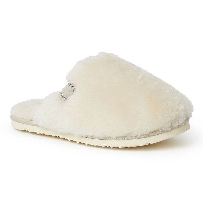 A white fluffy slipper with a soft faux fur exterior and branded patch detail on the side, featuring a flat, textured rubber sole.