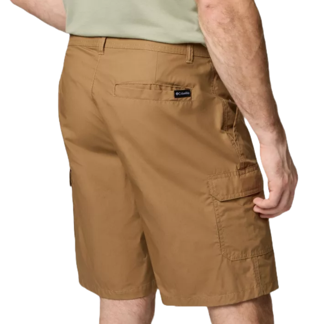 A person is wearing tan cargo shorts with multiple pockets and a visible Columbia logo on the back.