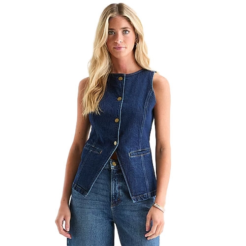A woman wearing a sleeveless, button-up denim vest paired with matching denim jeans.