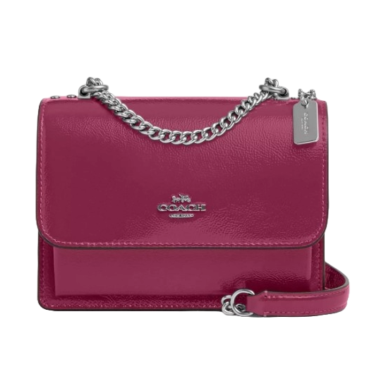 A maroon Coach Outlet Leather Mini Crossbody with a sleek design, featuring a silver chain strap, flap closure, and a small Coach logo on the front.