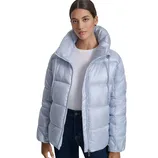 A woman wearing a light blue puffer jacket with a high collar, paired with a white shirt and dark jeans.