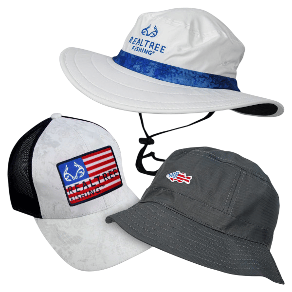 3-pack of Realtree Fishing hats includes a white boonie hat with a blue band, a white and black mesh-back cap with an American flag design, and a gray bucket hat with a small fish logo.