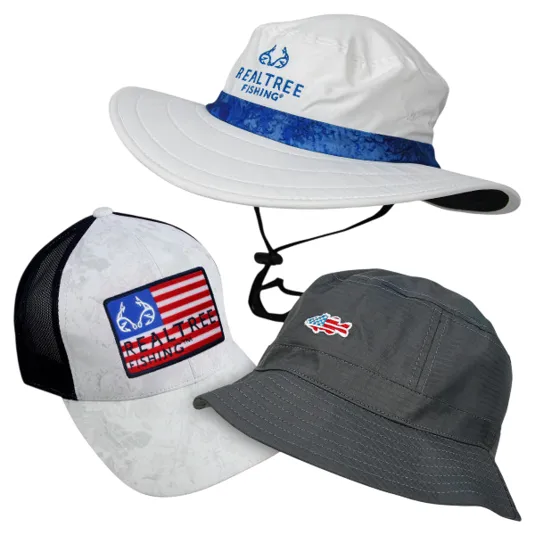 3-pack of Realtree Fishing hats includes a white boonie hat with a blue band, a white and black mesh-back cap with an American flag design, and a gray bucket hat with a small fish logo.