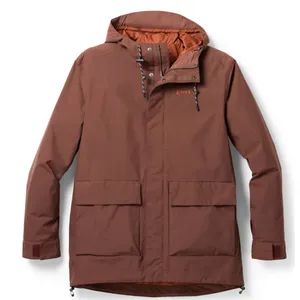 Brown winter jacket with a hood, featuring an REI logo, front flap pockets, and adjustable cuffs with Velcro.