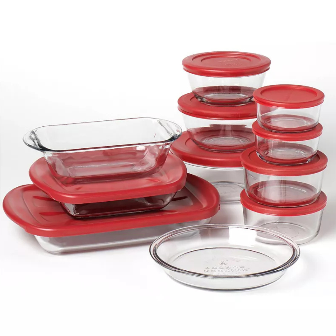A set of clear glass storage containers with red lids in various shapes and sizes, including rectangular, circular, and oval dishes.