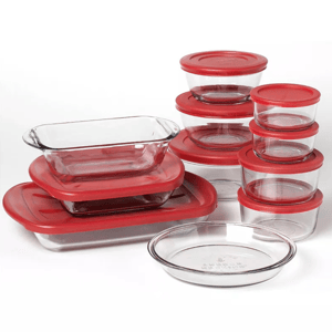 A set of clear glass storage containers with red lids in various shapes and sizes, including rectangular, circular, and oval dishes.