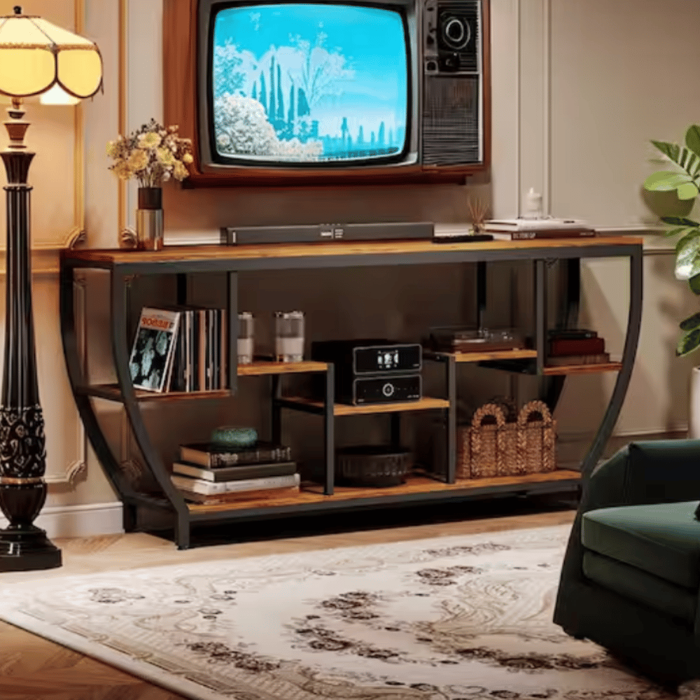 A vintage television set is mounted above a console table with shelves, holding vinyl records, a radio, and decorative items, flanked by a floor lamp and a patterned rug in a stylish living room setup.
