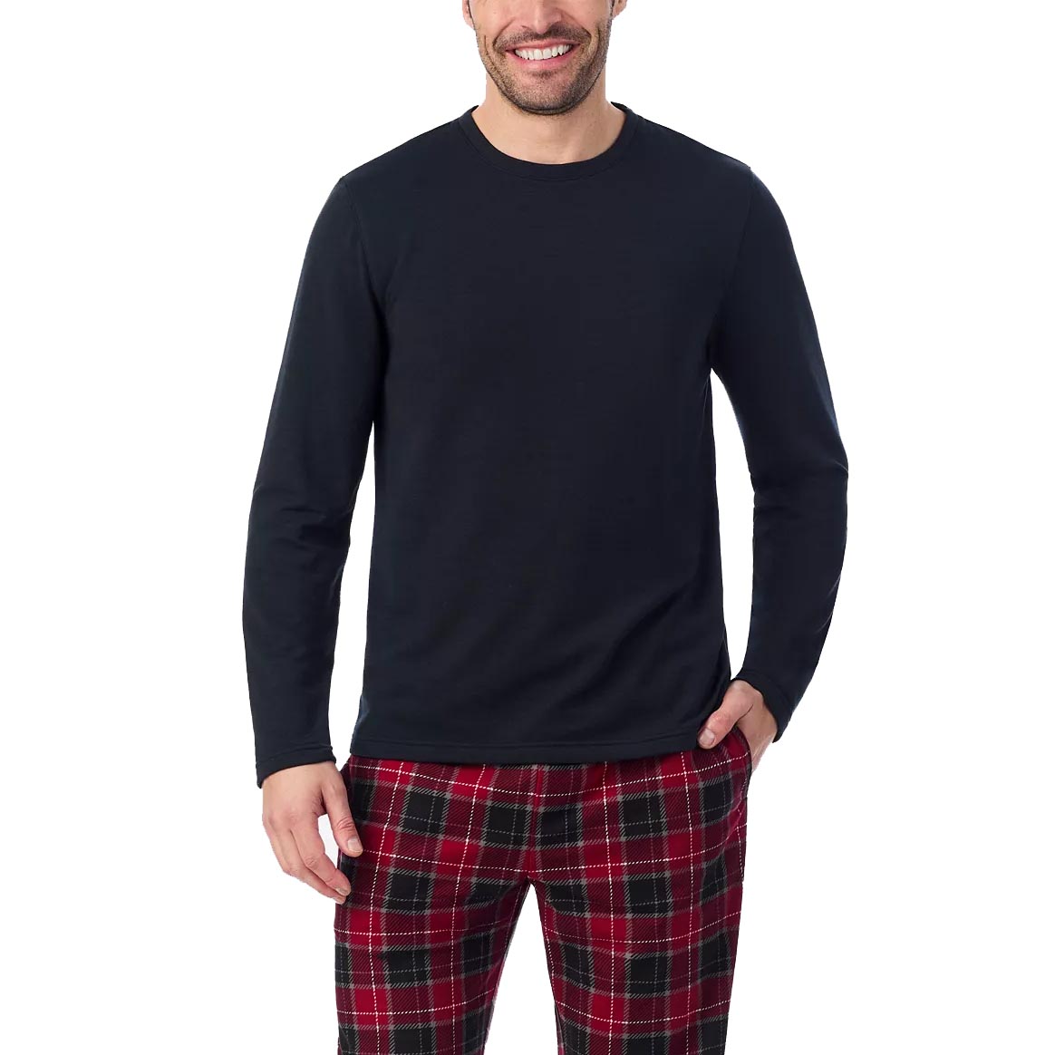 A person is wearing a black long-sleeve shirt paired with red and black plaid pants against a plain background.