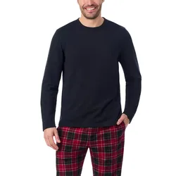 A person is wearing a black long-sleeve shirt paired with red and black plaid pants against a plain background.