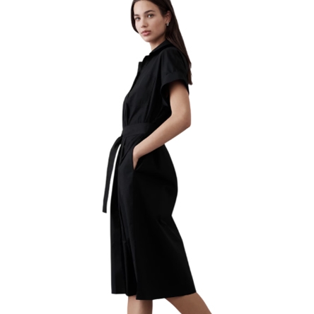 A black midi-length shirtdress with short sleeves, featuring a tie waist for adjustable fit and a collared neckline. It has a simple, elegant design suitable for various occasions.