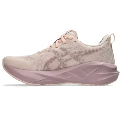 A light pink athletic shoe with a cushioned sole and minimalistic design, featuring a subtle pattern on the side and lace-up closure.