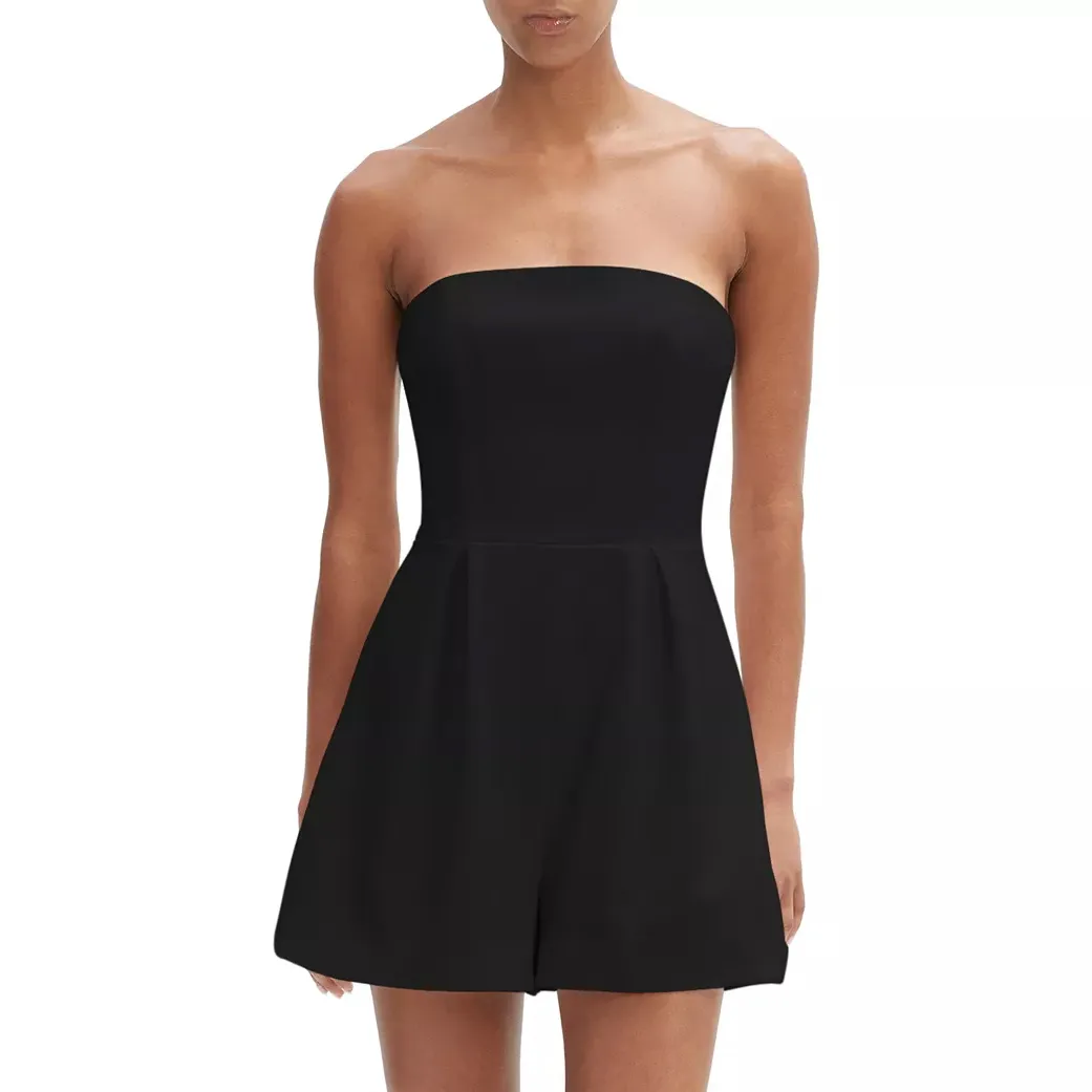 Strapless black romper with a fitted bodice and pleated shorts, suitable for casual or semi-formal occasions.