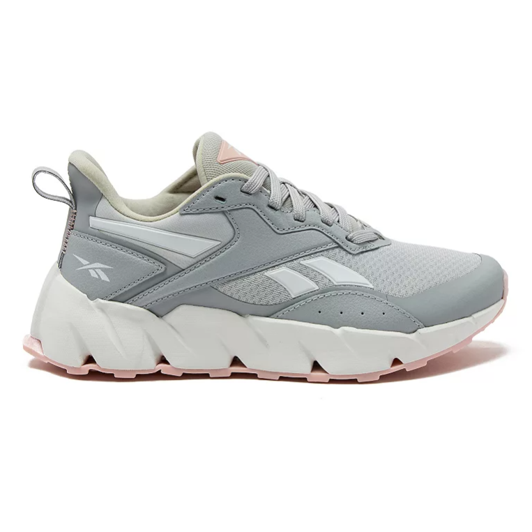 A gray and white Reebok sneaker with a chunky sole and pink accents, featuring the Reebok logo on the side and a pull tab at the heel.