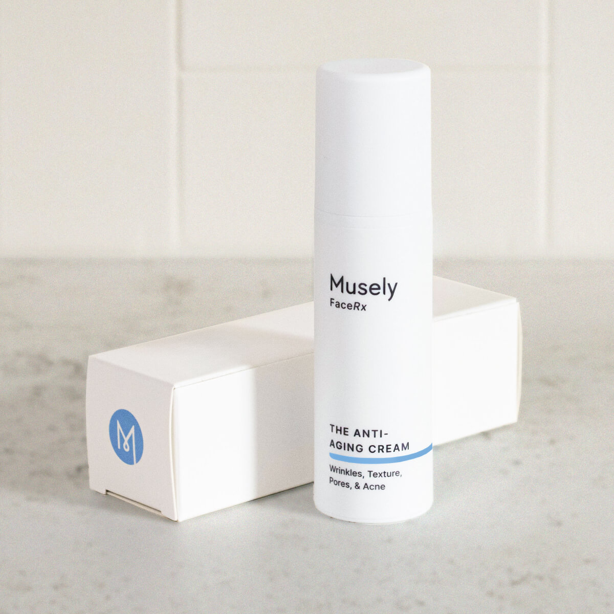 Musely FaceRx Anti-Aging Cream, targeting wrinkles, texture, pores, and acne, in a white cylindrical bottle with a blue stripe at the bottom, accompanied by a white box with a blue M logo.