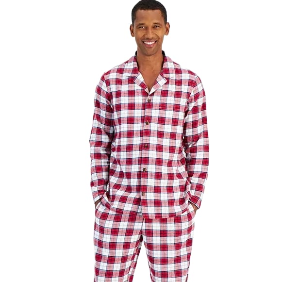 A man is wearing a red and white plaid pajama set with long sleeves and buttoned front. The outfit includes a matching pair of pants.