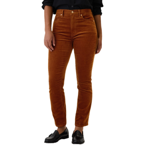 High-waisted vintage corduroy pants in a rich rust color, featuring a straight-leg fit and belt loops, paired with black loafers and a rolled-up long sleeve shirt for a classic look.