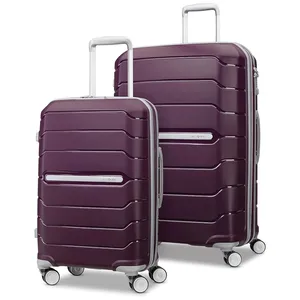 Two purple, hard-shell suitcases with silver handles and four wheels, designed for easy mobility and likely part of a luggage set.