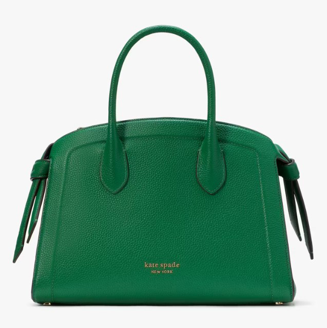 Green Kate Spade handbag with short handles and a zippered top closure.