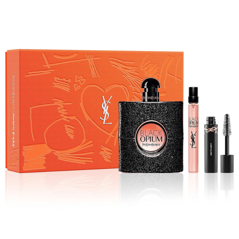 YSL gift set includes Black Opium Eau de Parfum, a travel-size perfume, and a Lash Clash mascara. The set is presented in an orange box adorned with the Yves Saint Laurent logo and artistic designs.