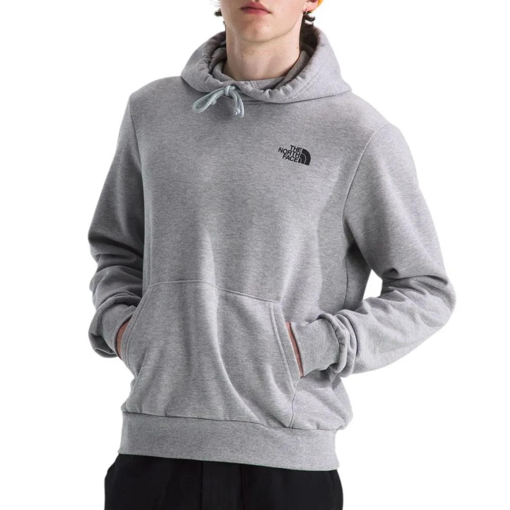 A person is wearing a gray The North Face hoodie with a kangaroo pocket. The hoodie features the brand's logo on the left chest.