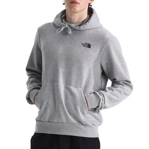 A person is wearing a gray The North Face hoodie with a kangaroo pocket. The hoodie features the brand's logo on the left chest.